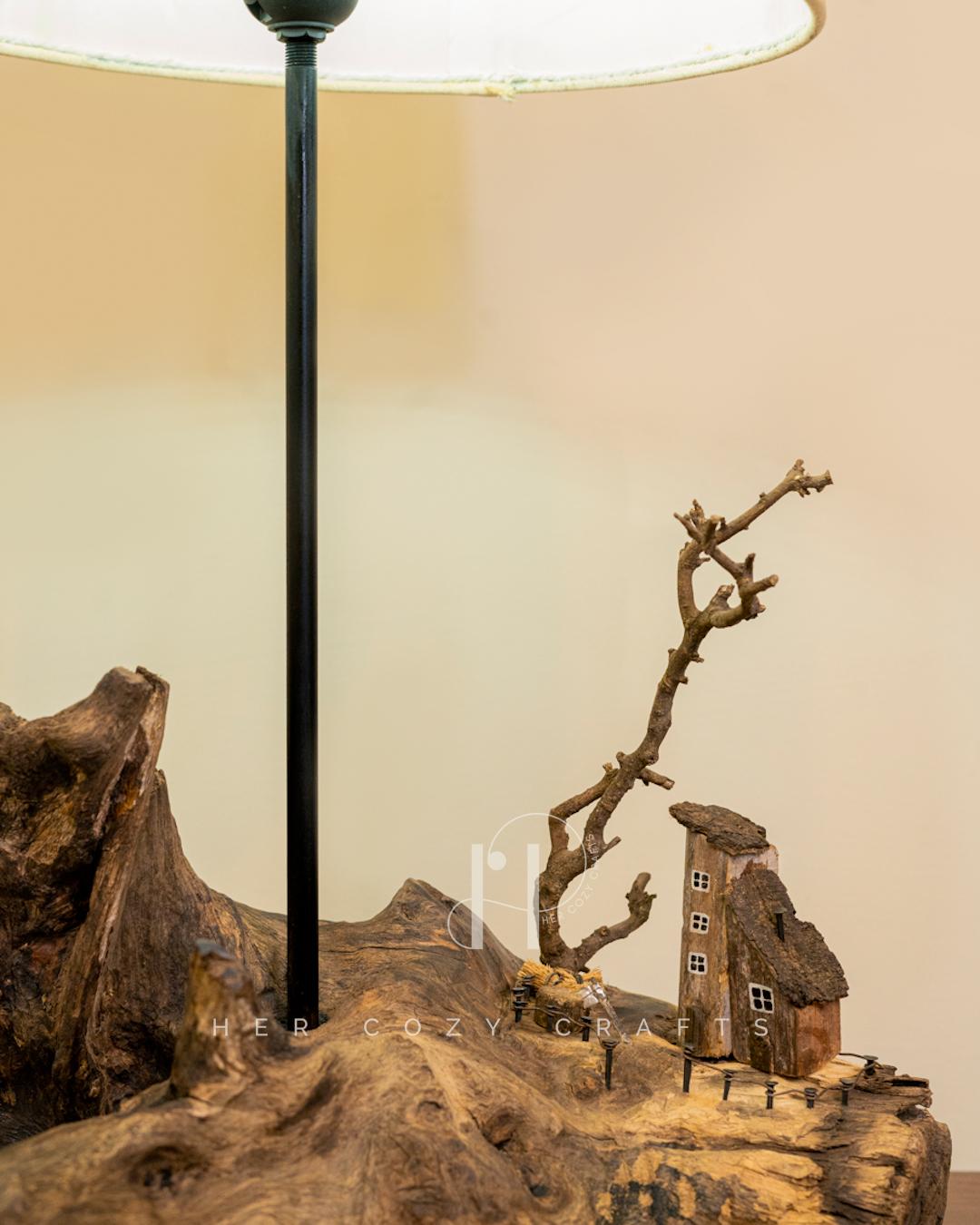 Darkwood Cove Lamp - Dark driftwood base with drum shade and village scene.