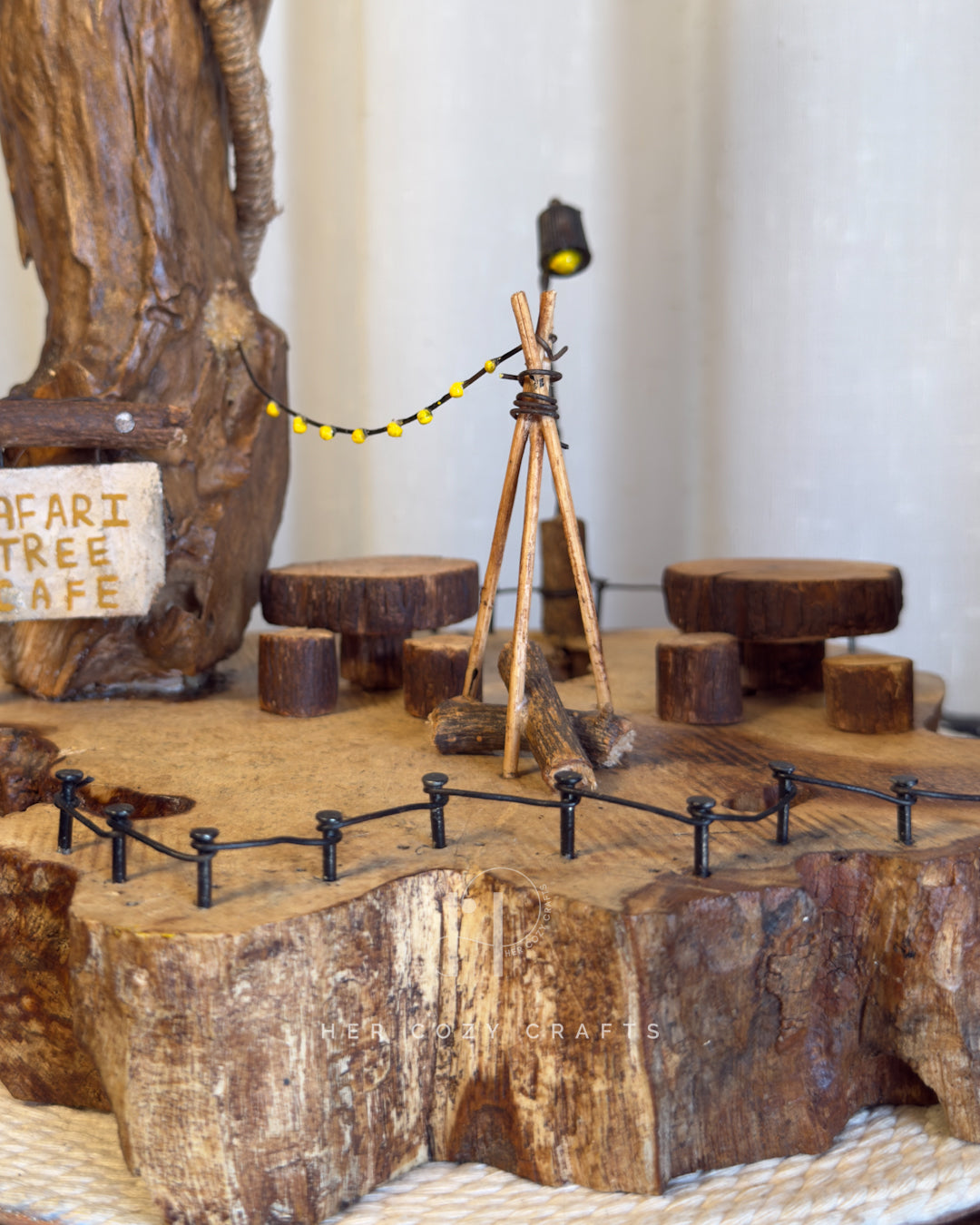 Safari Yard Lamp - Tall driftwood branch with hanging bulb and cafe scene