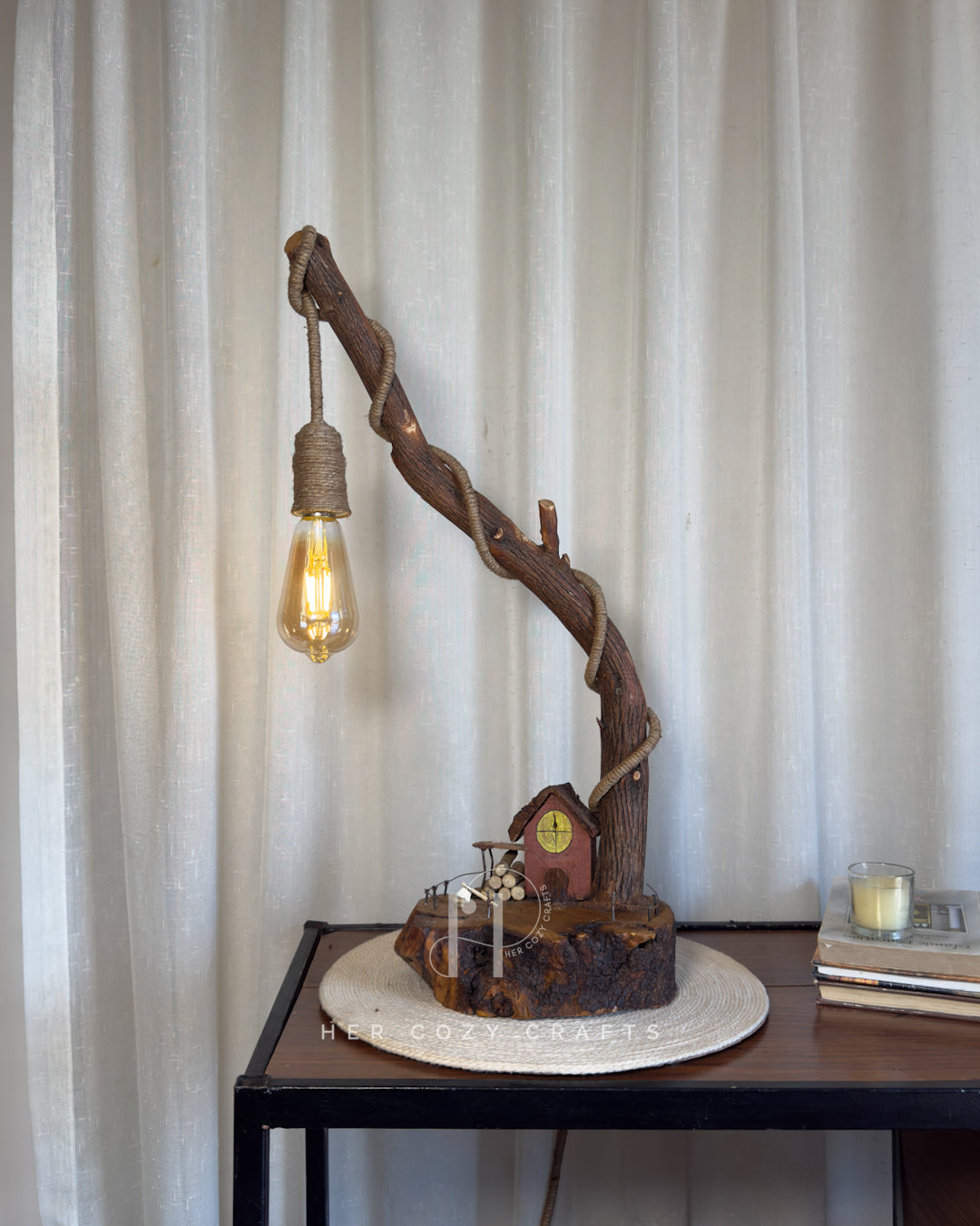 Red Hut Reach Lamp - Tall leaning branch with hanging light and cottage yar