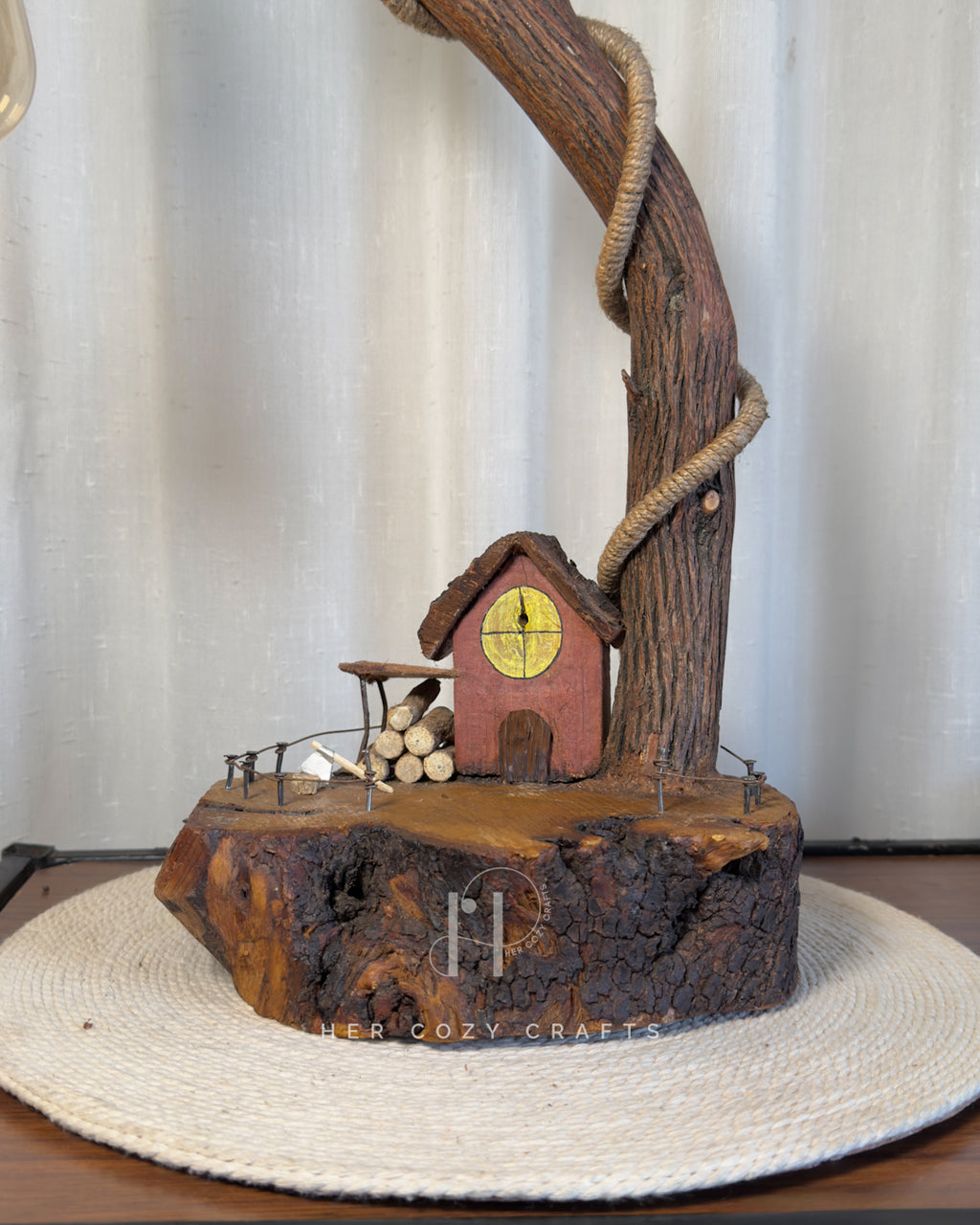 Red Hut Reach Lamp - Tall leaning branch with hanging light and cottage yar