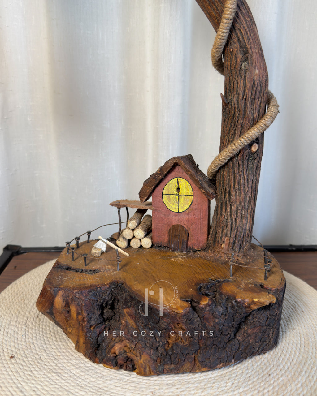 Red Hut Reach Lamp - Tall leaning branch with hanging light and cottage yar