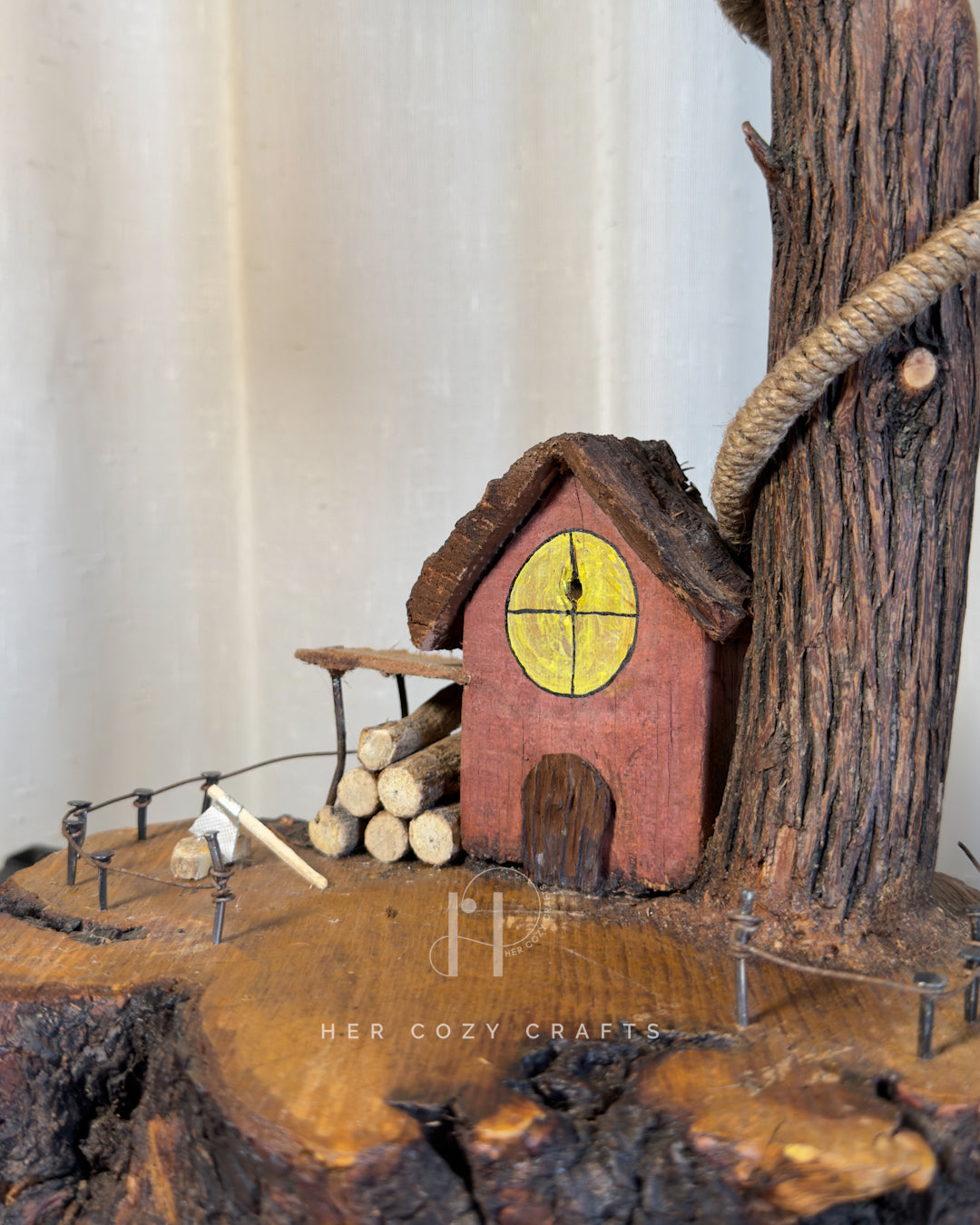 Red Hut Reach Lamp - Tall leaning branch with hanging light and cottage yar