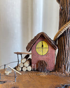 Red Hut Reach Lamp - Tall leaning branch with hanging light and cottage yar