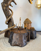 Wildwood Arc Lamp-Natural signature table lamp Base with Rope-Wrapped Hanging Bulb & Miniature Village Detail